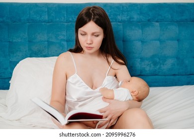 A Mother With A Baby In Her Hands Reading A Book In Bed. Everyday Life Of A Mother With An Infant. Educational Literature And Online Lessons On Newborn Care.