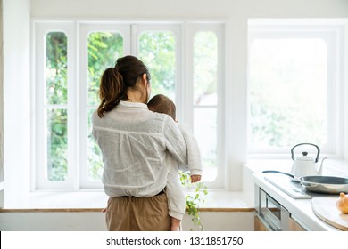 Mother and baby in the kitchen.