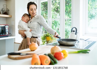 Mother and baby in the kitchen. - Powered by Shutterstock