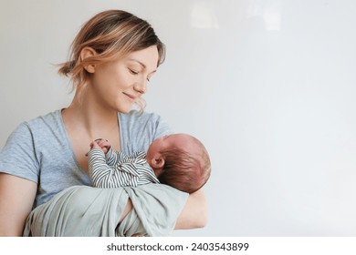 Mother and baby. Loving mom spending time with her little 2 weeks old child at home. Image of bonding mother and baby, healthy physical and mental development of child, happy maternity and family. - Powered by Shutterstock