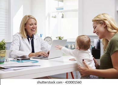 Mother And Baby Meeting With Female Doctor In Office