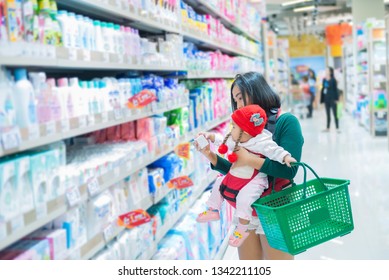 Mother And Baby Shopping In The Supermarket,Thai Woman Has A Daugther