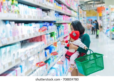 Mother And Baby Shopping In The Supermarket,Thai Woman Has A Daugther