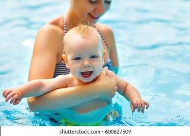 Mother And Baby Swim  In The Pool

