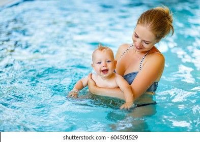 Mother And Baby Swim  In The Pool

