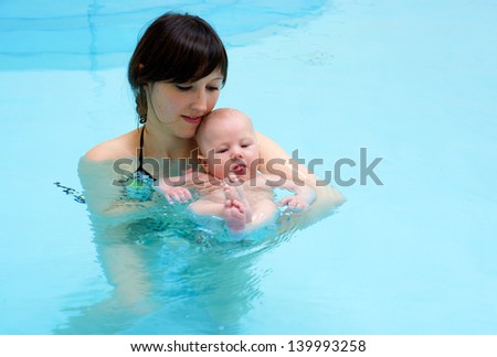 Mother with baby in swimming pool