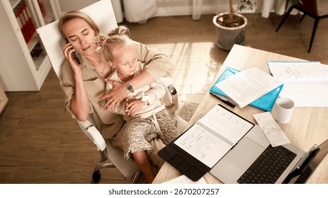 Mother balancing work responsibilities while caring for her young child at home