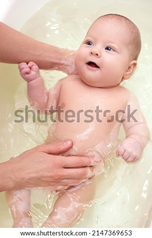 Similar – Image, Stock Photo Newborn in the bathtub held by her mother