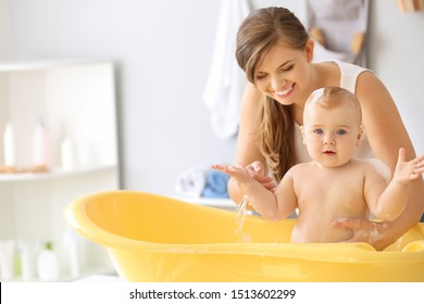 Mother Bathing Her Cute Little Baby At Home