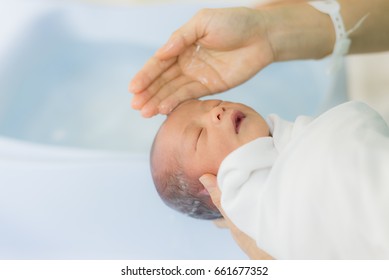 Mother Is Bathing And Washing For Newborn Baby.