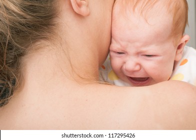 Mother from Behind Holding Crying Newborn Baby
