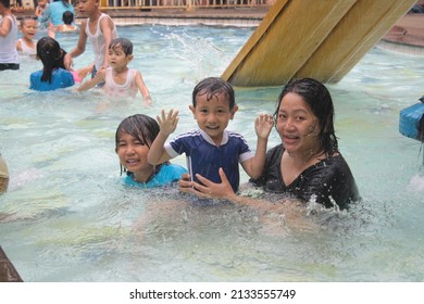 A Mother In Black Accompanies Her Young Children Swimming In A Pool That Is Not Deep, Bogor, September 30, 2018