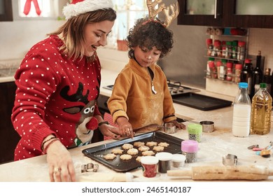 Mother, boy and cookies with christmas, love and dough learning for baking in kitchen together. Smile, food and celebration with woman, adopted son and child in home to prepare sweet treat or snack - Powered by Shutterstock