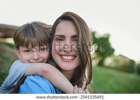 Similar – Image, Stock Photo Little boy kissing his mother on a field in summer