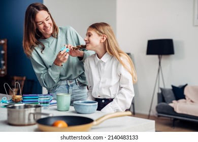 Mother Braids Her Daughter's Braids Before School At Breakfast