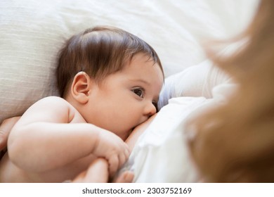 Mother breast-feeding her baby girl - Powered by Shutterstock