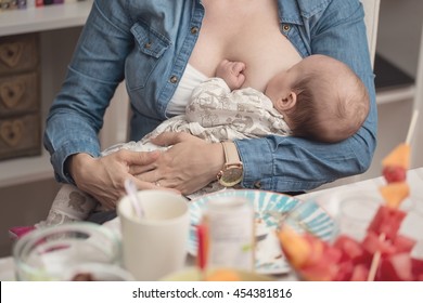 Mother breastfeeding her newborn baby girl during the lunch - breastfeeding on demand - instagram style effect applied