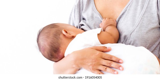 mother breastfeeding and hugging baby. Young mom breast feeding her newborn child. Baby eating milk before he sleeping. Milk from mom’s breast is a natural medicine for children  Mother day 