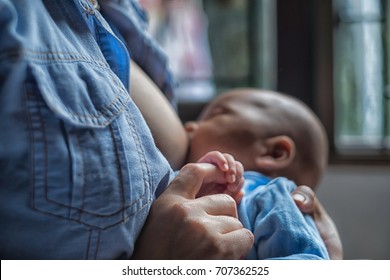 Mother Breastfeeding And Hugging Baby. Young Mom Breast Feeding Her Newborn Child. Lactation Infant Concept. Baby Eating Milk Before He Sleep. Mother Feed Her Six Months Baby With Breast Milk.