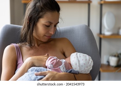 Mother breastfeeds newborn baby - wide view