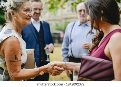 Mother Of The Bride Greeting The Guests At A Wedding Party