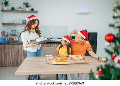 mother bringing drink for family christmas dinner in dining room - Powered by Shutterstock