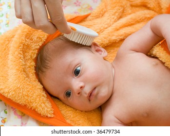 mother brushing her son with comb