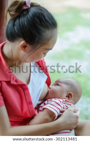Mother care. Breast feeding baby. mother feeding baby soft focus. young mother breast feeding her infant in outdoor