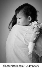 Mother Carrying Her Baby Sick In Hospital,saline Intravenous (IV) On Hand Baby ,black&white Picture