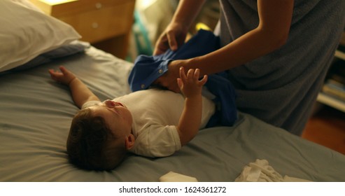 
Mother Changing Baby At Night. Mom Putting Pijama On Infant Boy Before Sleep