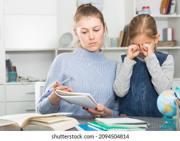 Mother Checks School Assignments Little Daughter. High Quality Photo