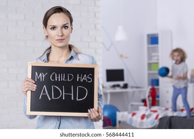 Mother Of Child With ADHD Holding Small Blackboard With Text