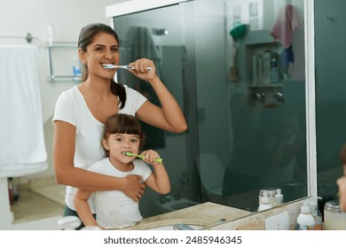 Mother, child and brushing teeth portrait in bathroom for dental hygiene, health and wellness learning. Home, brushing and young girl with toothbrush, teeth and cleaning at morning with care - Powered by Shutterstock