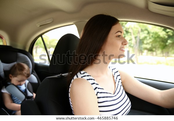 Mother and child\
in car. Safety driving\
concept
