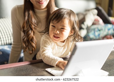 Mother And Child (children Playing With Computer)