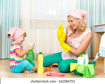 Mother With Child Cleaning Room And Having Fun