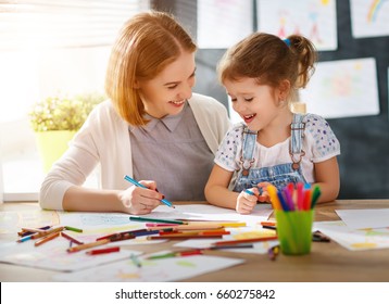 mother and child daughter draws are engaged in creativity in kindergarten
