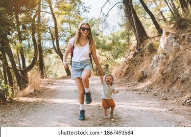 Mother with child daughter walking in forest family vacation mom travel with baby hiking together active healthy lifestyle outdoor happy emotions 