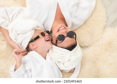 Mother with child doing beauty treatment together. Happy family mother and child daughter in towel and bathrobe in the bathroom. beauty salon concept, wellness spa, Long banner format, top view.
