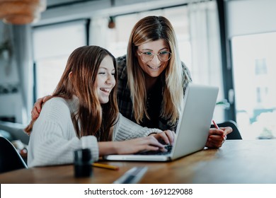 Mother And Child Doing Homeschooling, E-learning At Home Because Of The Corona Virus Pandemic Covid-19 Quarantine