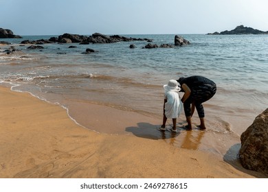 mother and child explore rocky beach, uncovering nature’s secrets. - Powered by Shutterstock