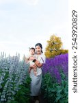 Mother and child in the flower field,mother and little daughter in a flowering lavender field enjoying her scent