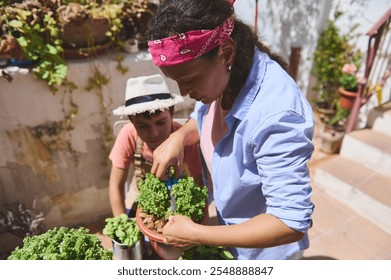 A mother and child are gardening together outdoors. They are nurturing plants, showcasing teamwork and bonding. The setting is bright and sunny, reflecting a peaceful and joyful activity. - Powered by Shutterstock