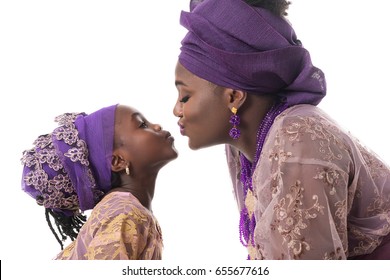 Mother And Child Girl Kissing.African Traditional Purple Clothing. Isolated On The White Studio Background