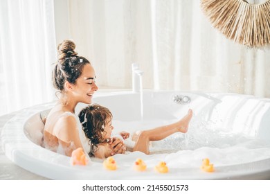 Mother And Child Having Bubble Bath. 