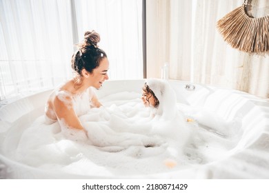 Mother And Child Having Bubble Bath. 