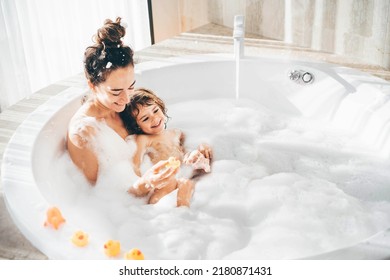 Mother and child having bubble bath.  - Powered by Shutterstock