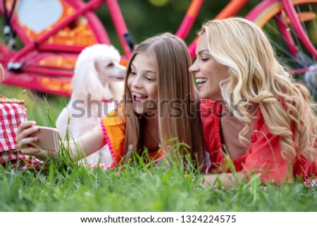 Mother and child having fun,take a selfie in the park.Happy family on picnic for mother’s day.