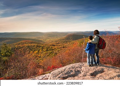 Mother And Child Hikers Enjoying The View At The Top Of A Mountain In The Fall