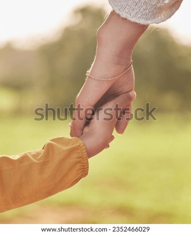 Mother, child and holding hands for walking in park for support, trust and care together or bonding in nature. Love, comfort and parent help kid in the morning sunshine with kindness on weekend